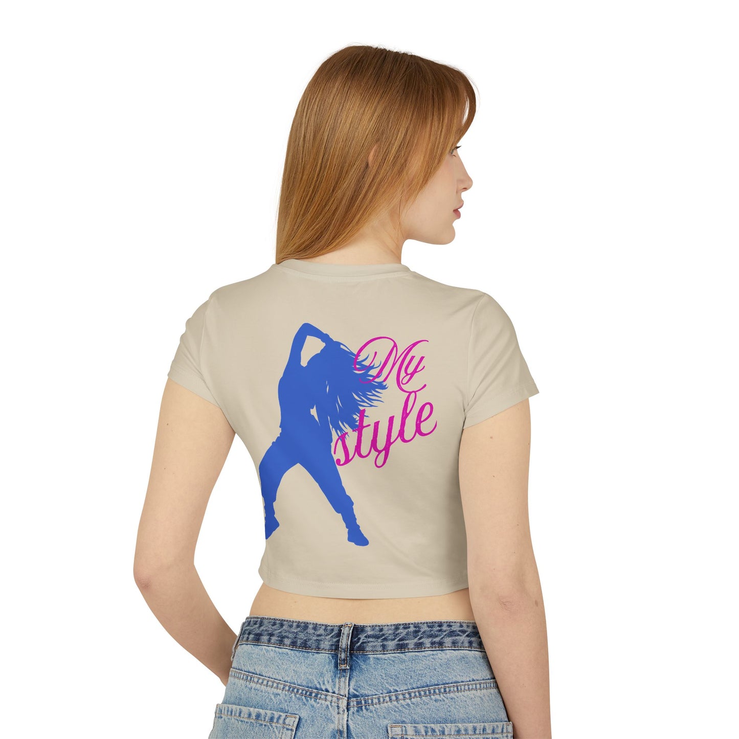 Young woman wearing a trendy graphic baby tee, styled with high-waisted jeans for a chic casual look